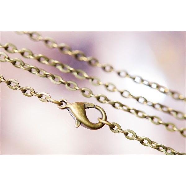 アンティークゴールドカラー メタルカメオ 花飾り女性の横顔レリーフ